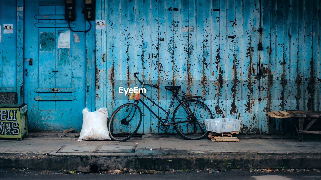 BICYCLE AGAINST BLUE WALL