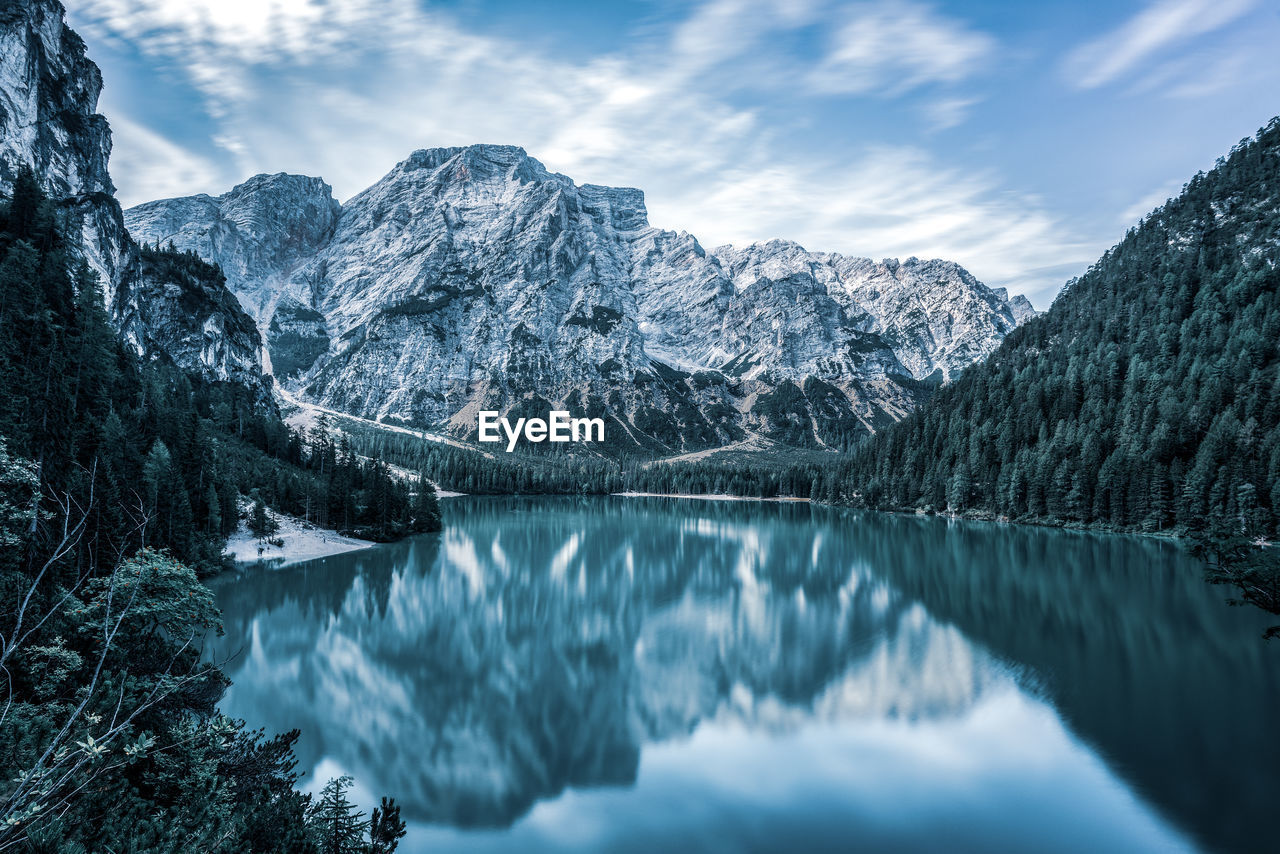 Scenic view of lake and snowcapped mountains against sky