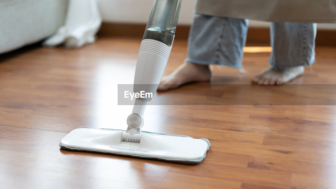 low section of person standing on hardwood floor