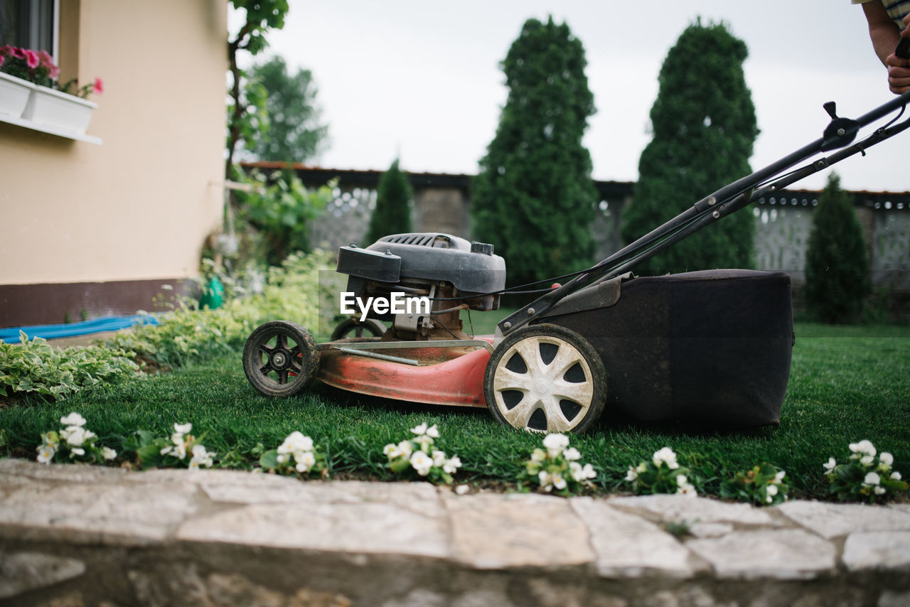 Lawn mowing in progress in a backyard.