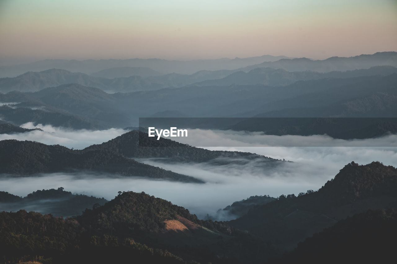 Scenic view of silhouette mountains against sky during sunset