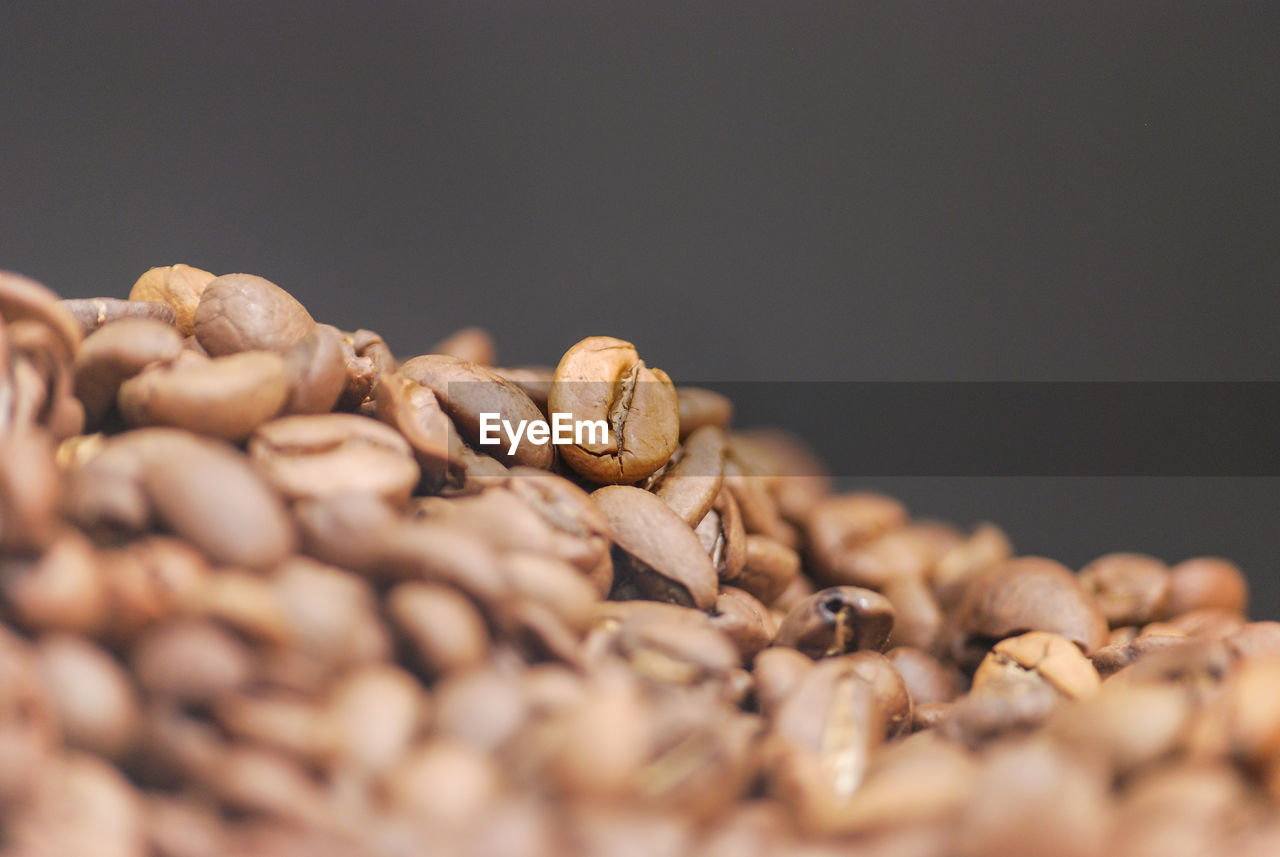 CLOSE-UP OF ROASTED COFFEE BEANS IN GLASS