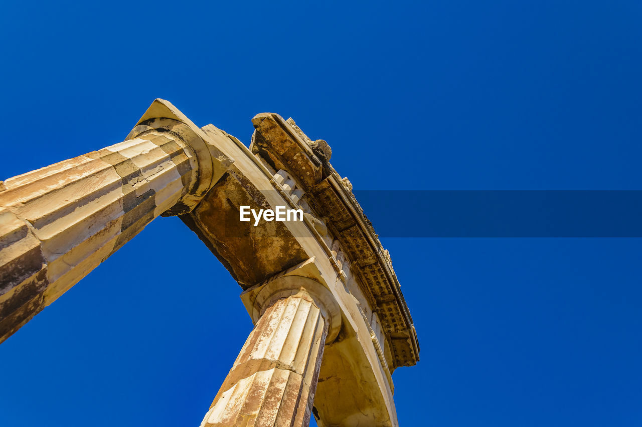 LOW ANGLE VIEW OF A TEMPLE AGAINST CLEAR BLUE SKY