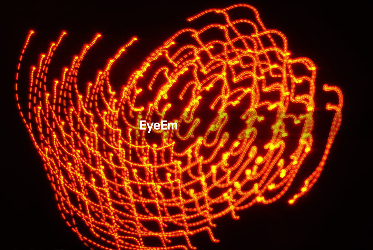 LOW ANGLE VIEW OF ILLUMINATED LIGHTING EQUIPMENT AGAINST BLACK BACKGROUND