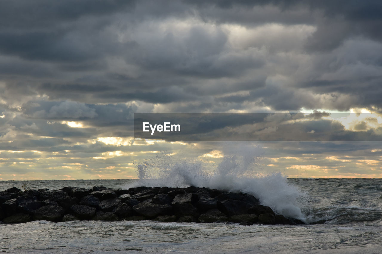 Scenic view of sea against storm clouds