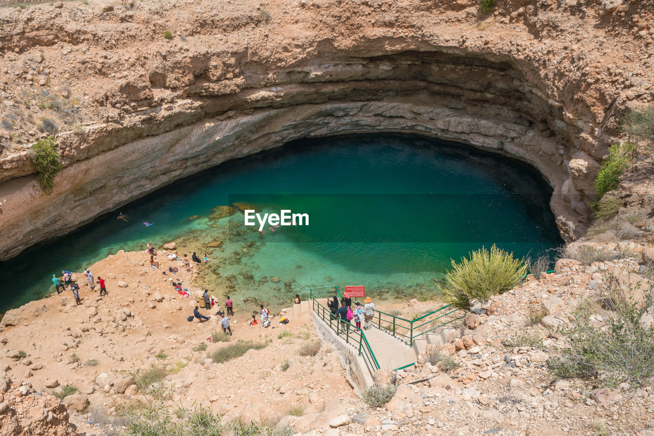 high angle view of people walking on cliff