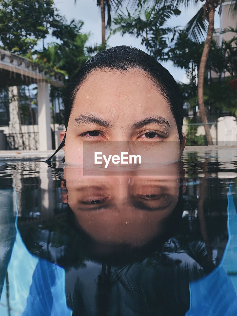 Portrait of teenage girl swimming in pool