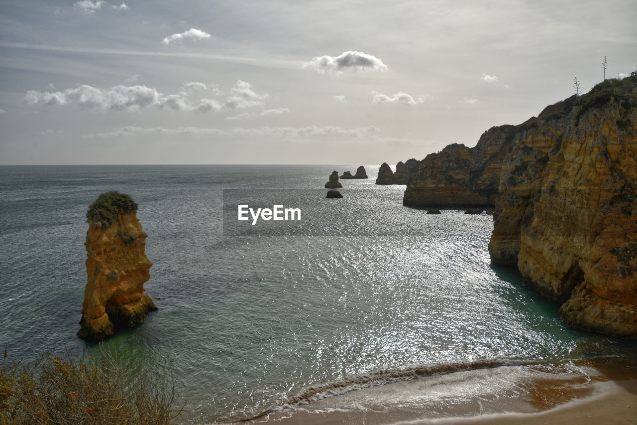 Rock formation on sea against sky