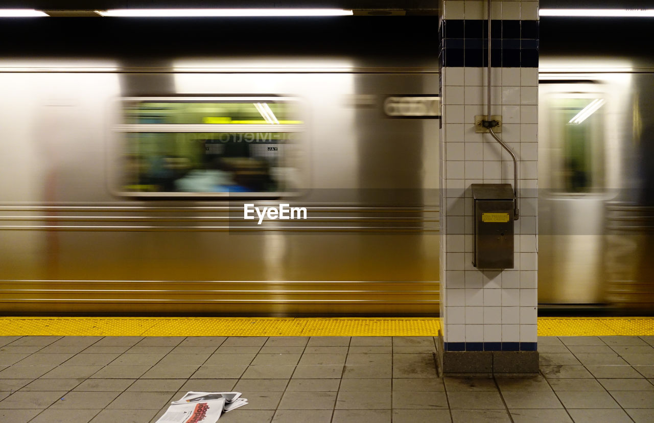 Blurred motion of train at railroad station