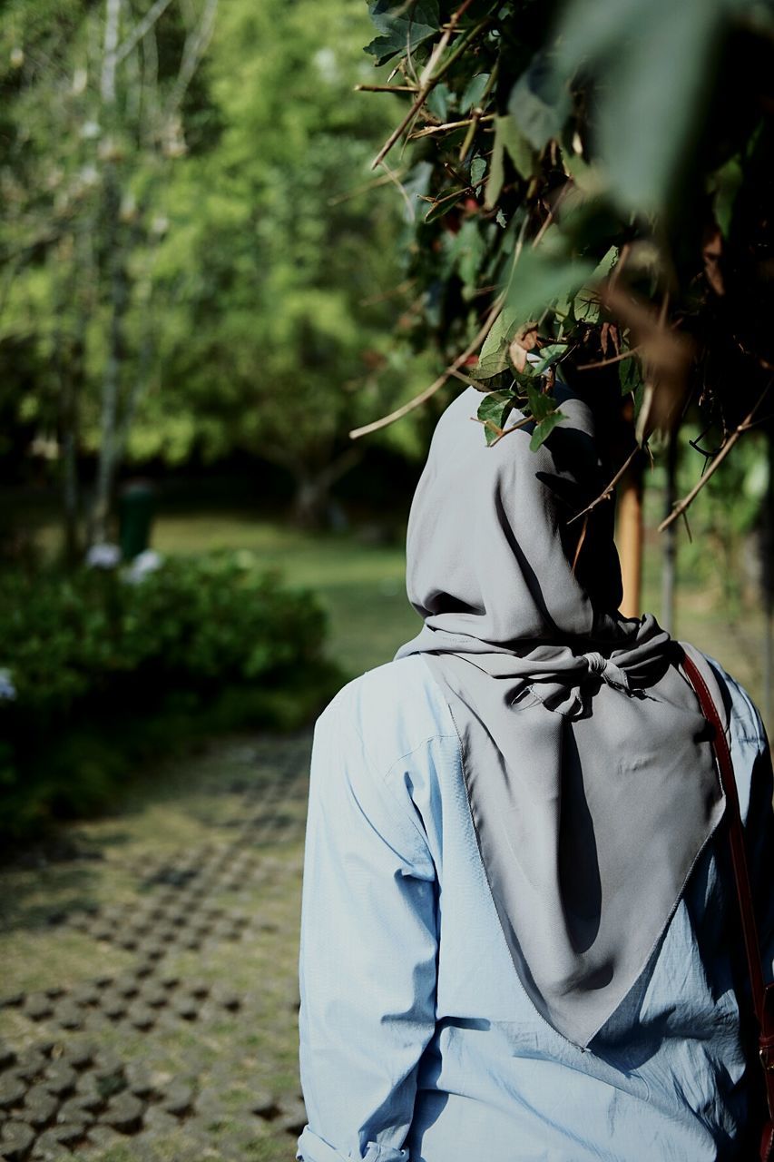 Rear view of person standing on footpath