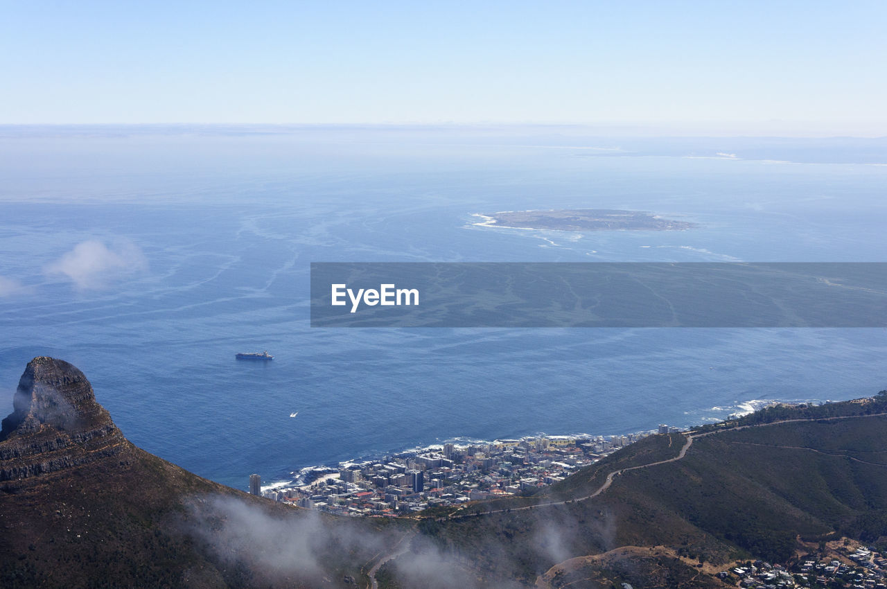 High angle view of sea and cityscape against sky