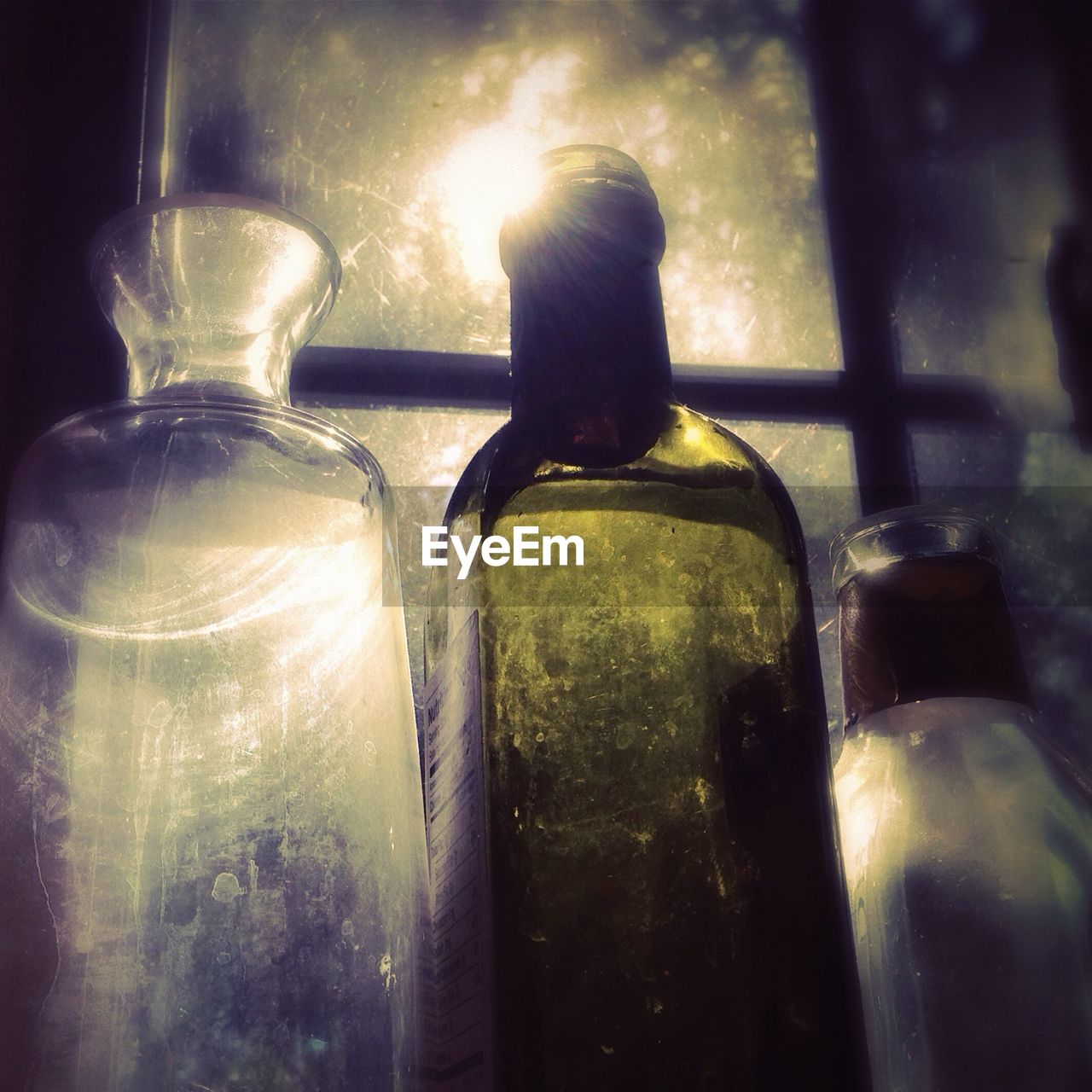 Close-up of bottles against window