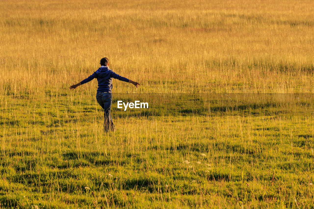 Woman walking on agricultural field