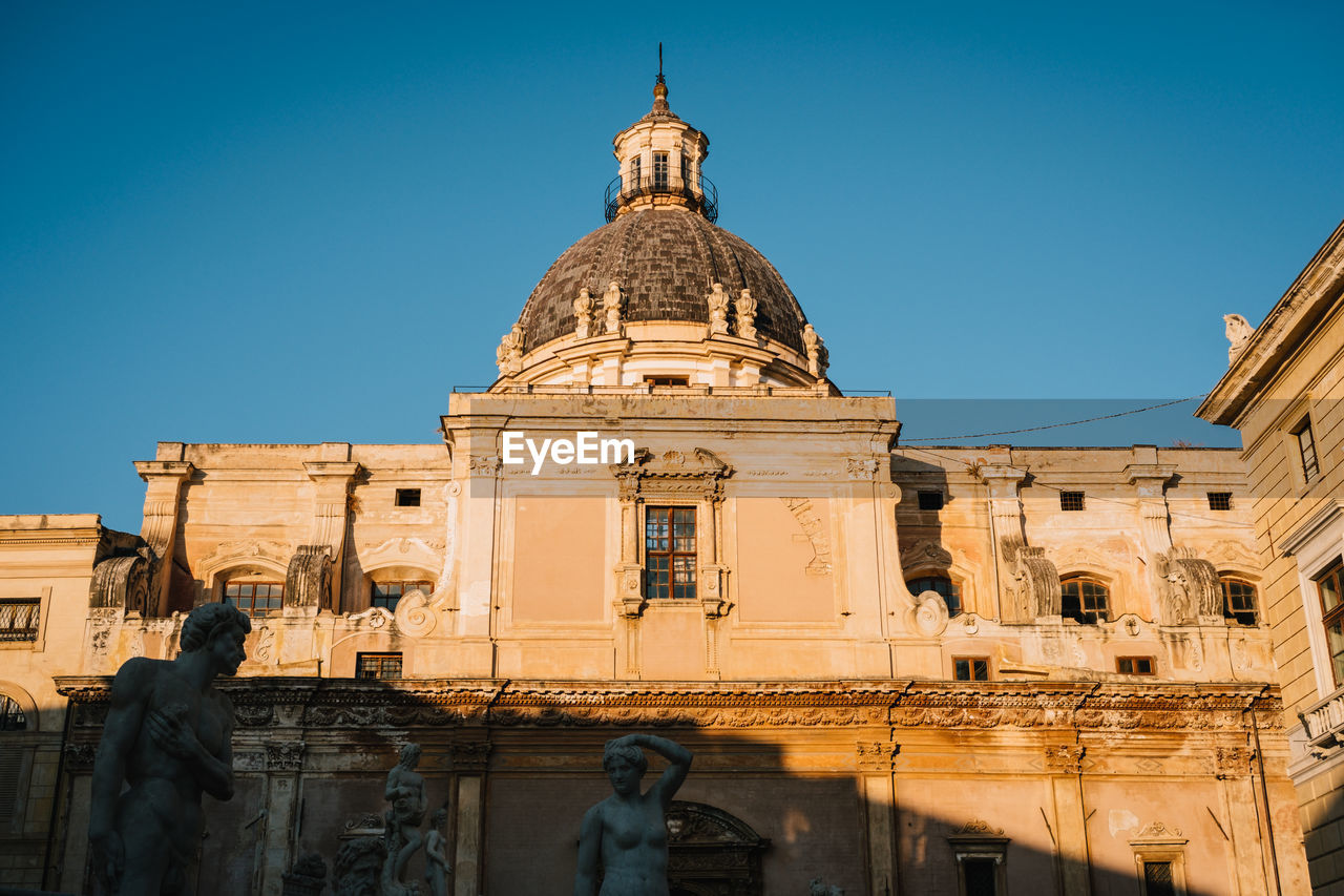 Low angle view of historic building against clear blue sky