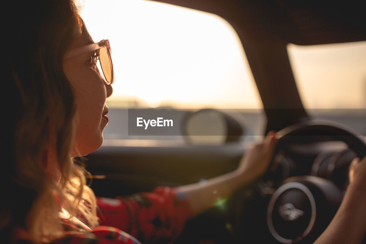 Close-up of woman driving car