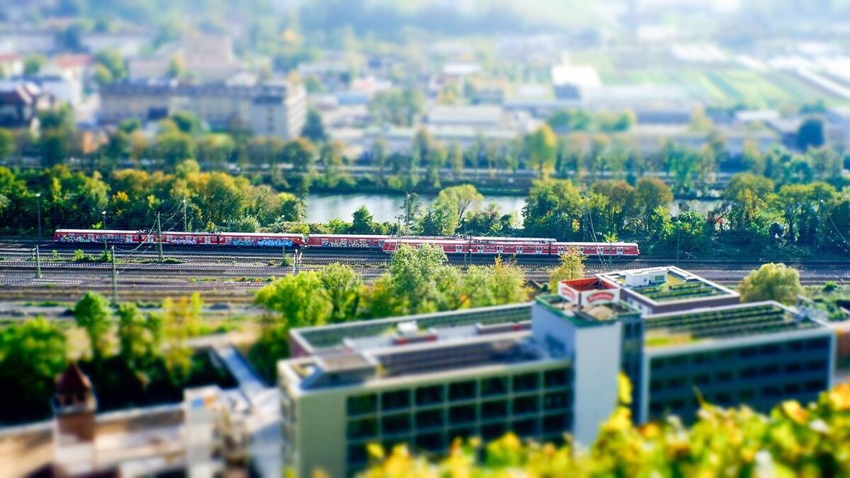 Tilt shift image of train in city