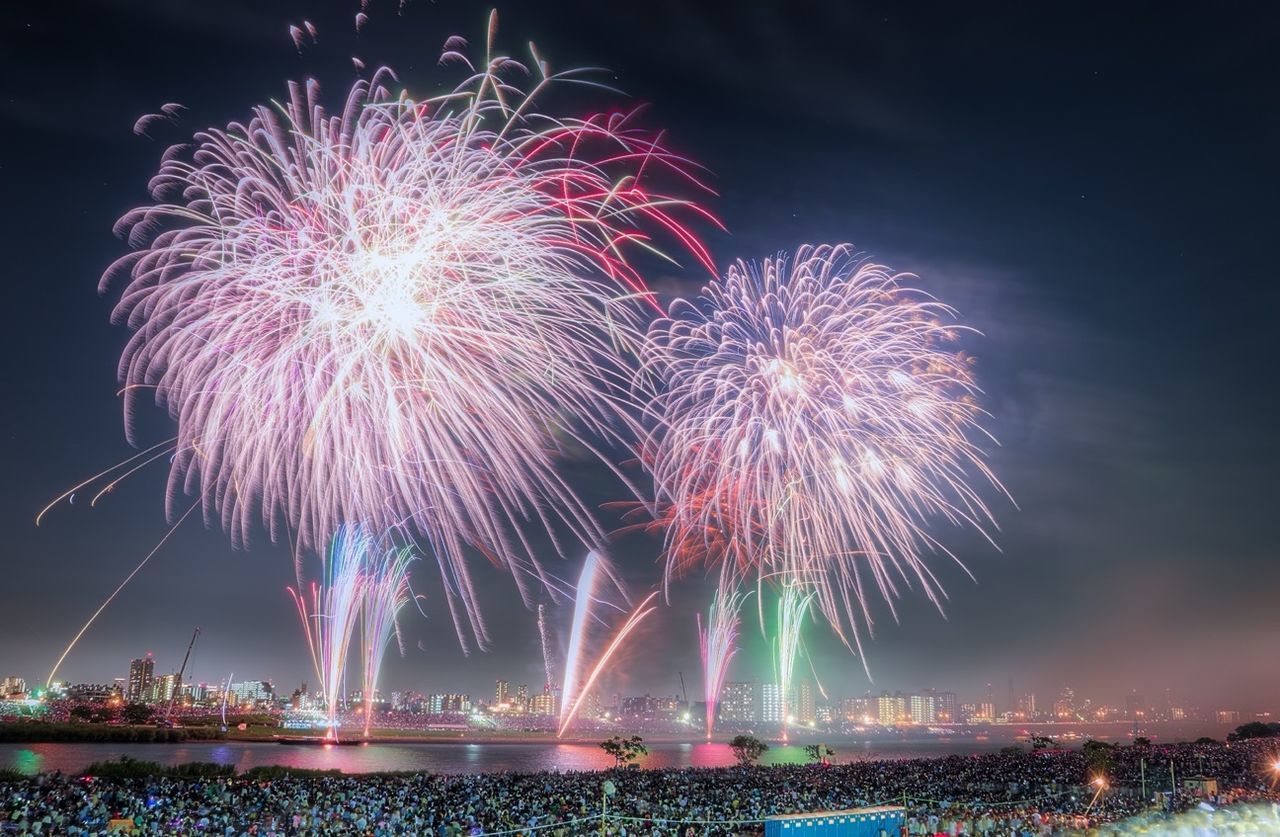 Firework display in city at night