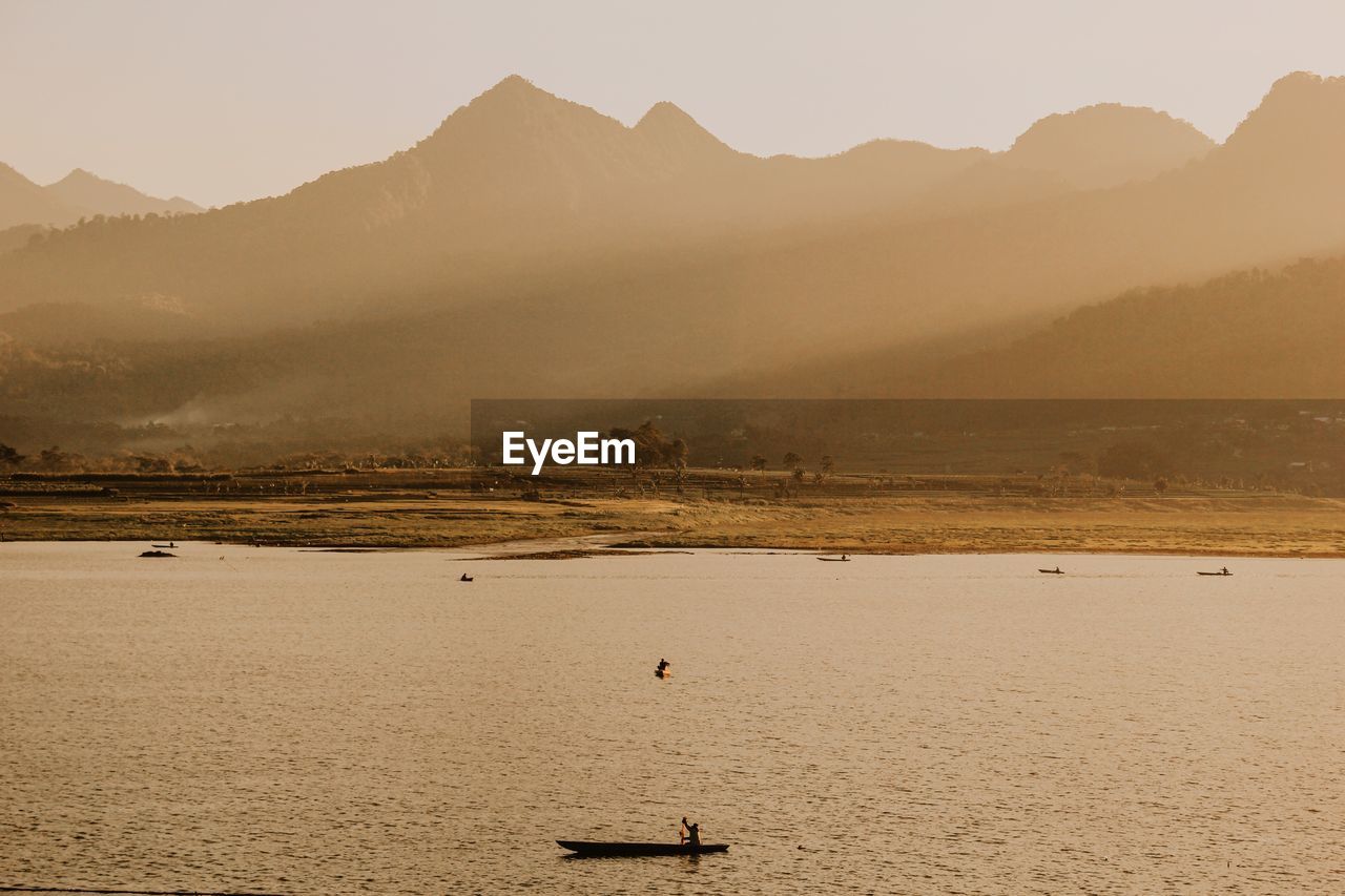 Man sitting on boat in lake