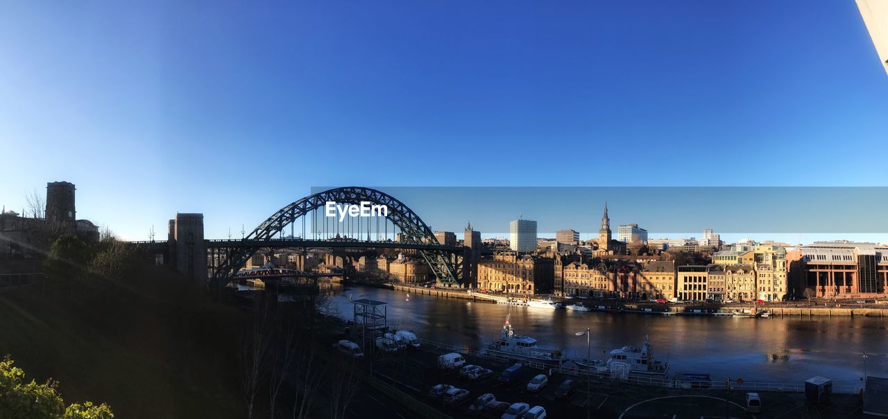View of bridge over river against blue sky