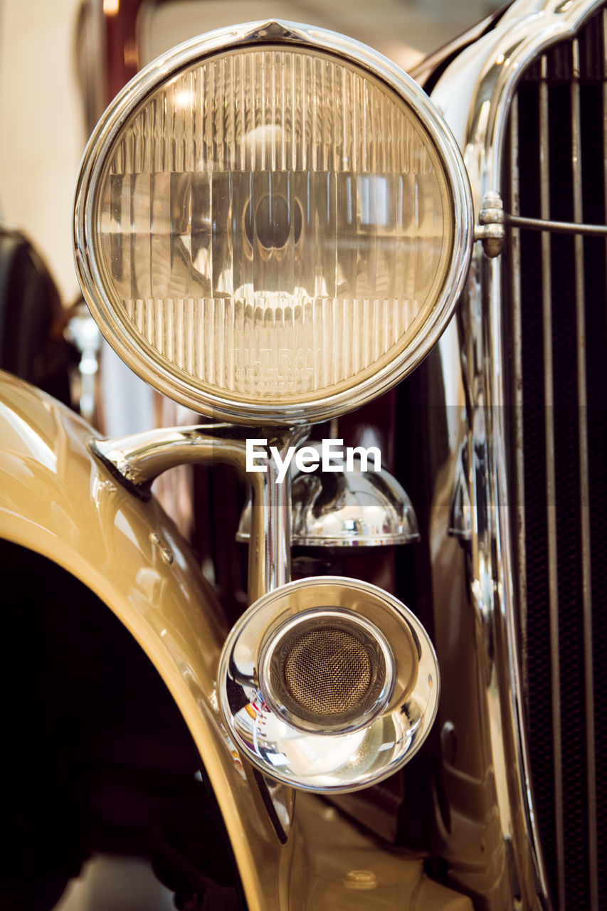 Cropped image of old-fashioned vintage car headlight