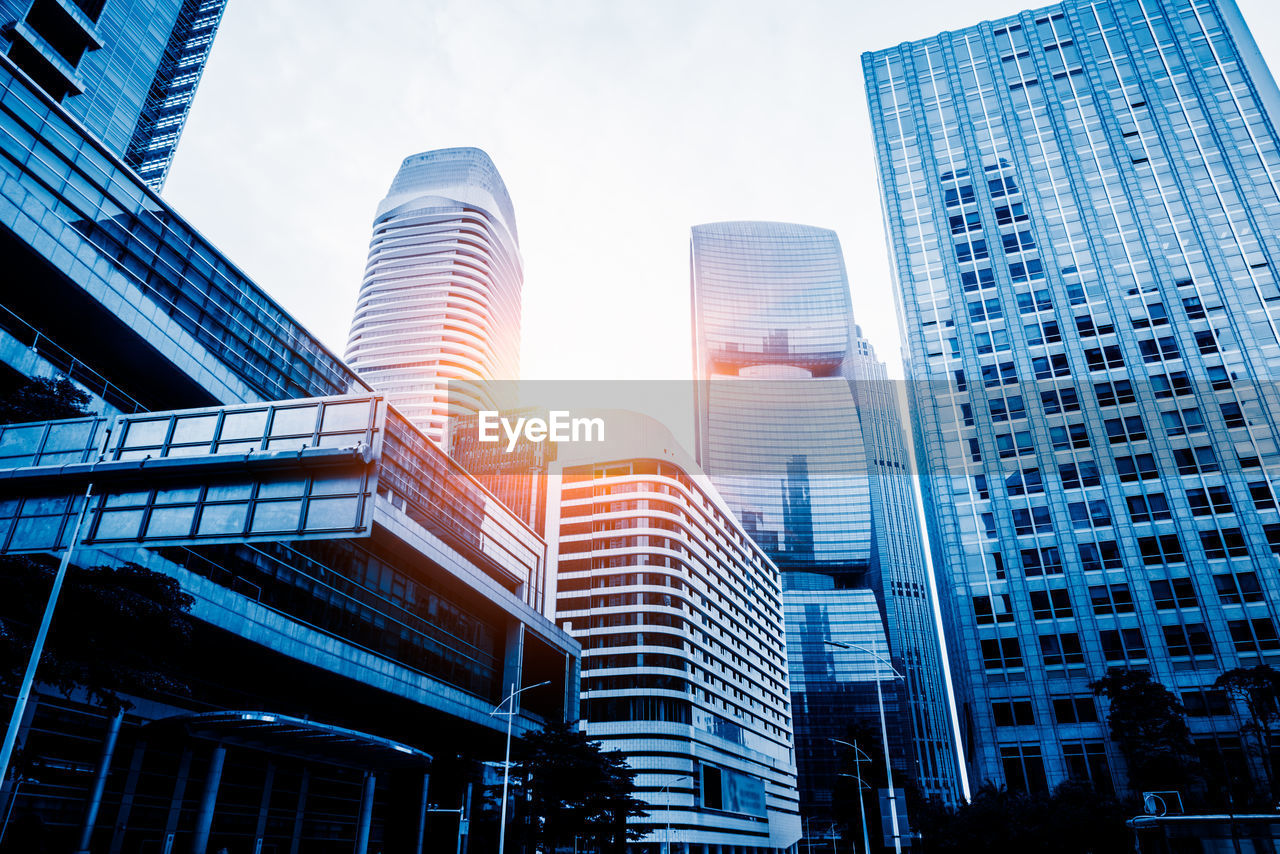 LOW ANGLE VIEW OF BUILDINGS IN CITY AGAINST SKY