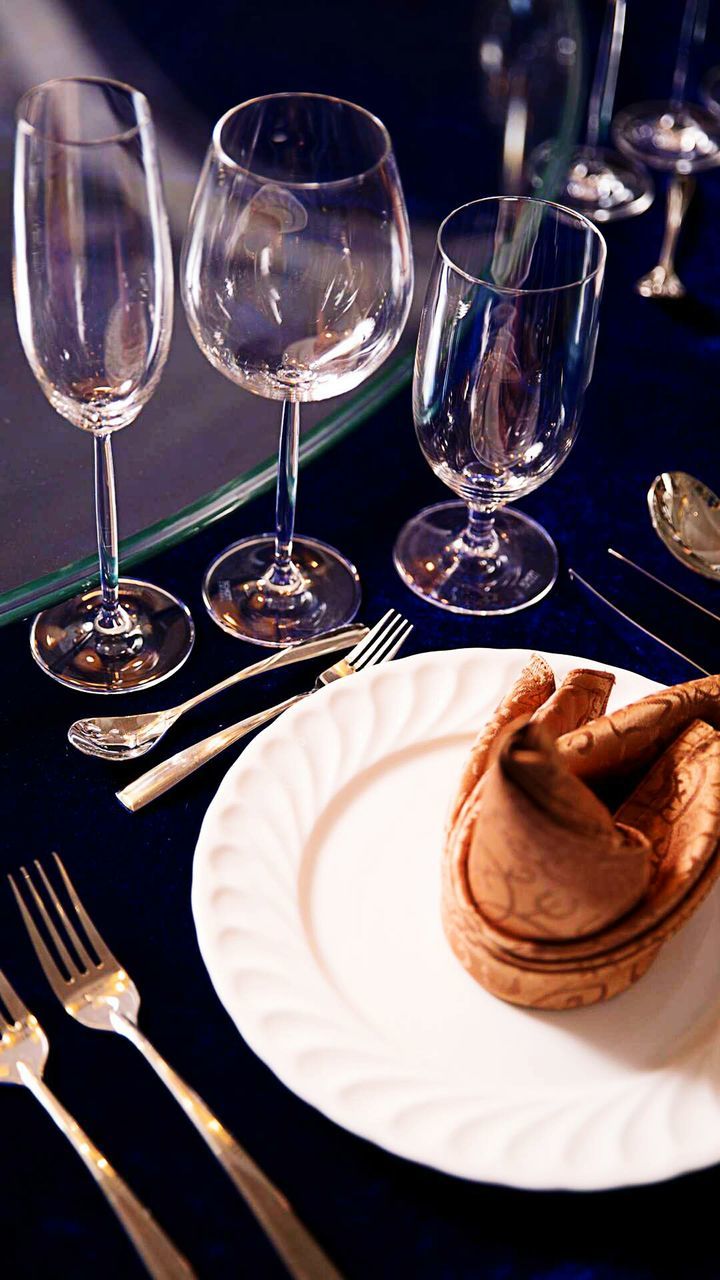 High angle view of plate and wineglasses on table