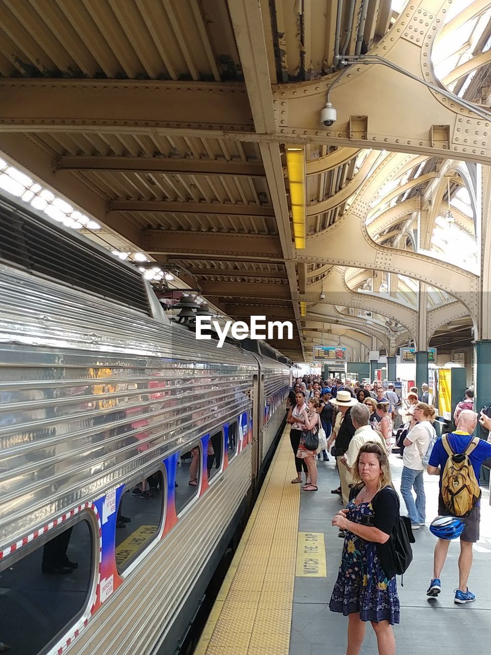 PEOPLE WAITING AT RAILROAD STATION