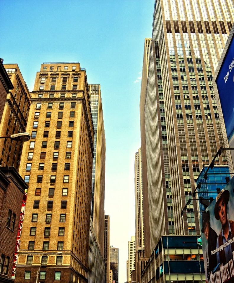 LOW ANGLE VIEW OF MODERN BUILDINGS AGAINST BLUE SKY