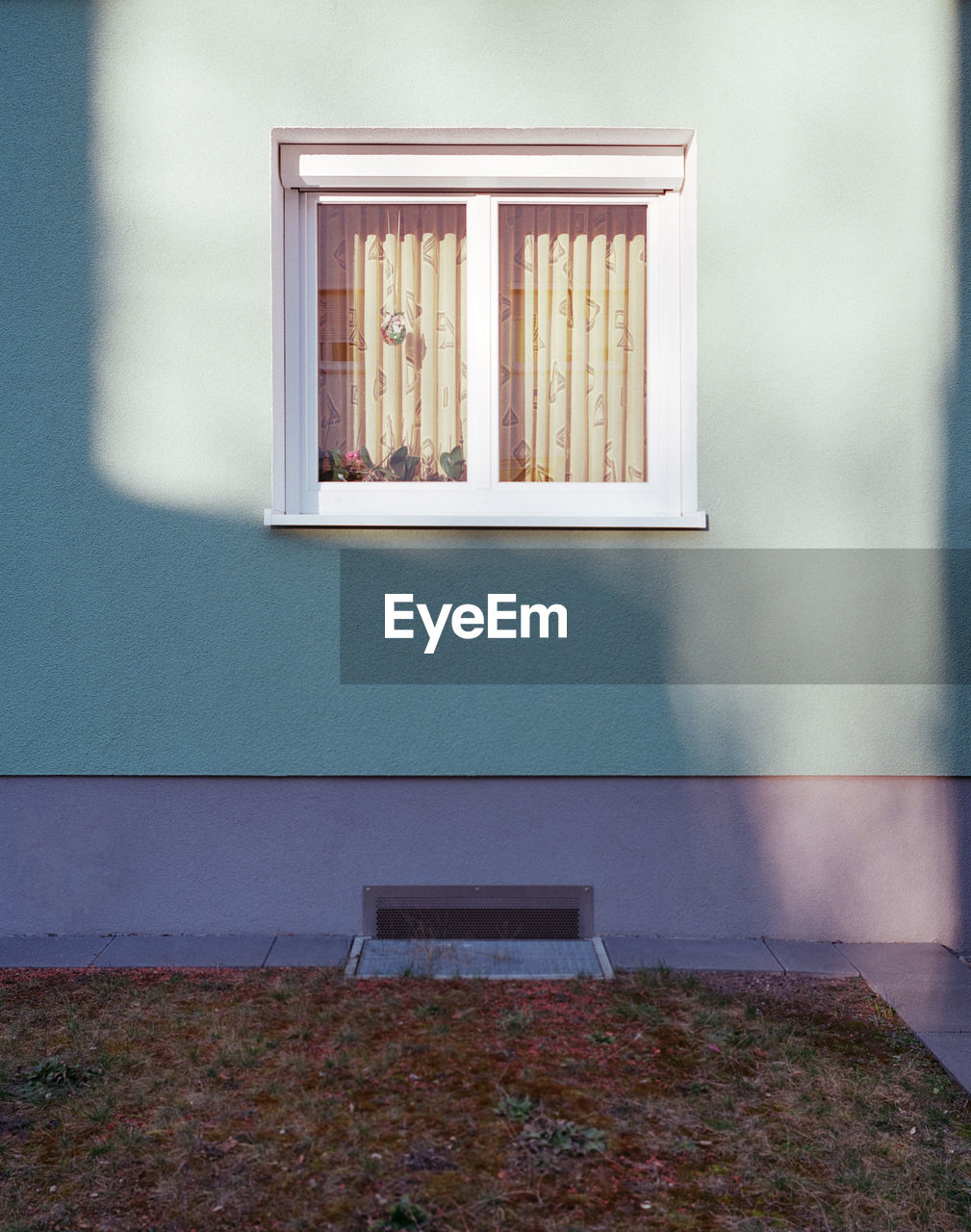 Sunlight falling on window and wall of building