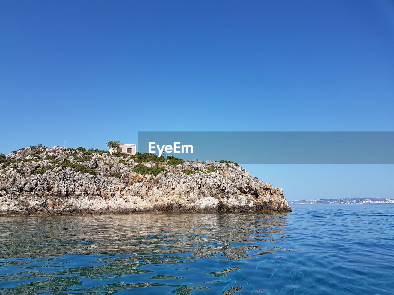 Scenic view of sea against clear blue sky