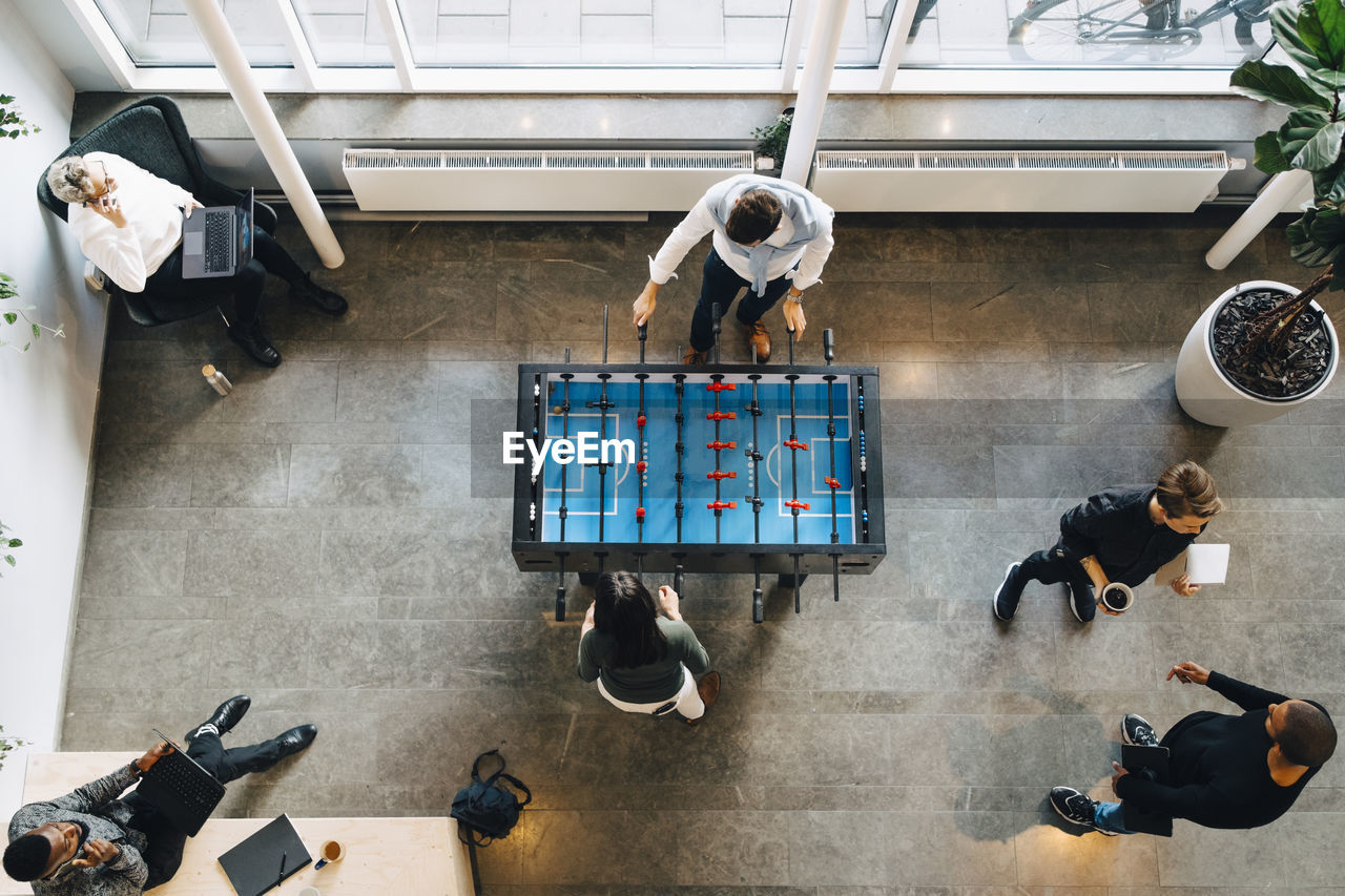 Directly above shot of business people taking break after office work