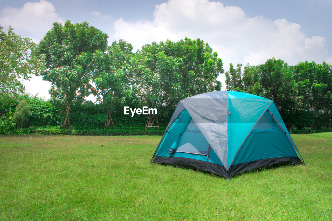 TENT ON FIELD AGAINST TREES