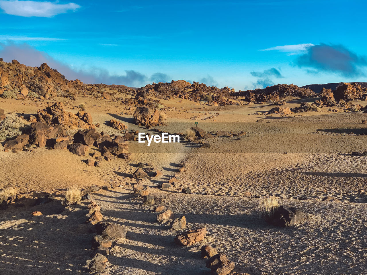 Scenic view of arid landscape against sky