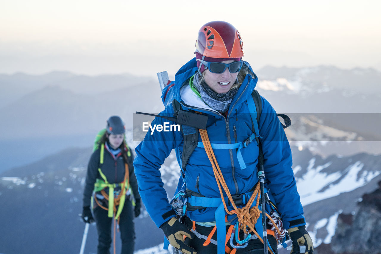 A portrait of a female mountaineer concentrating on her next steps