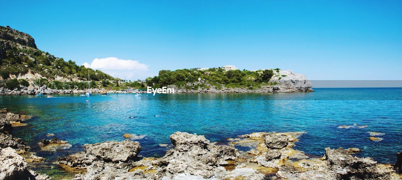 Scenic view of sea against blue sky