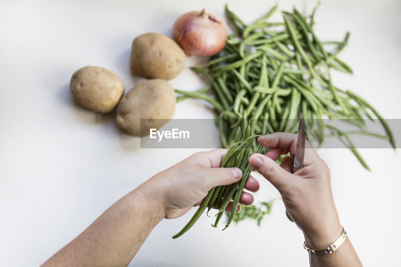 High angle view of woman hand preparing vegetables