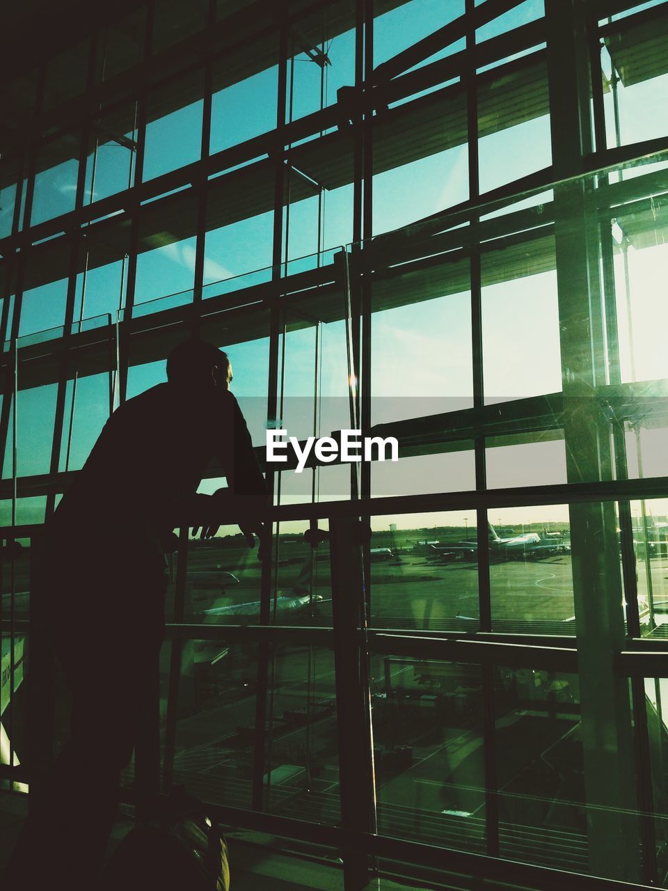 Man standing by railing at airport