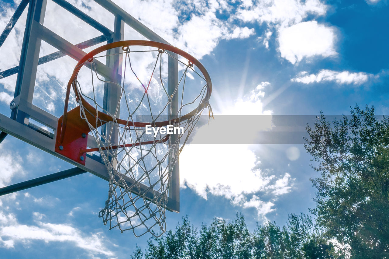 Basketball hoop against blue sky. low angle view