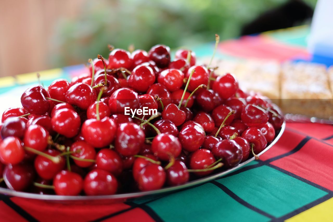 Close-up of red cherries served on table