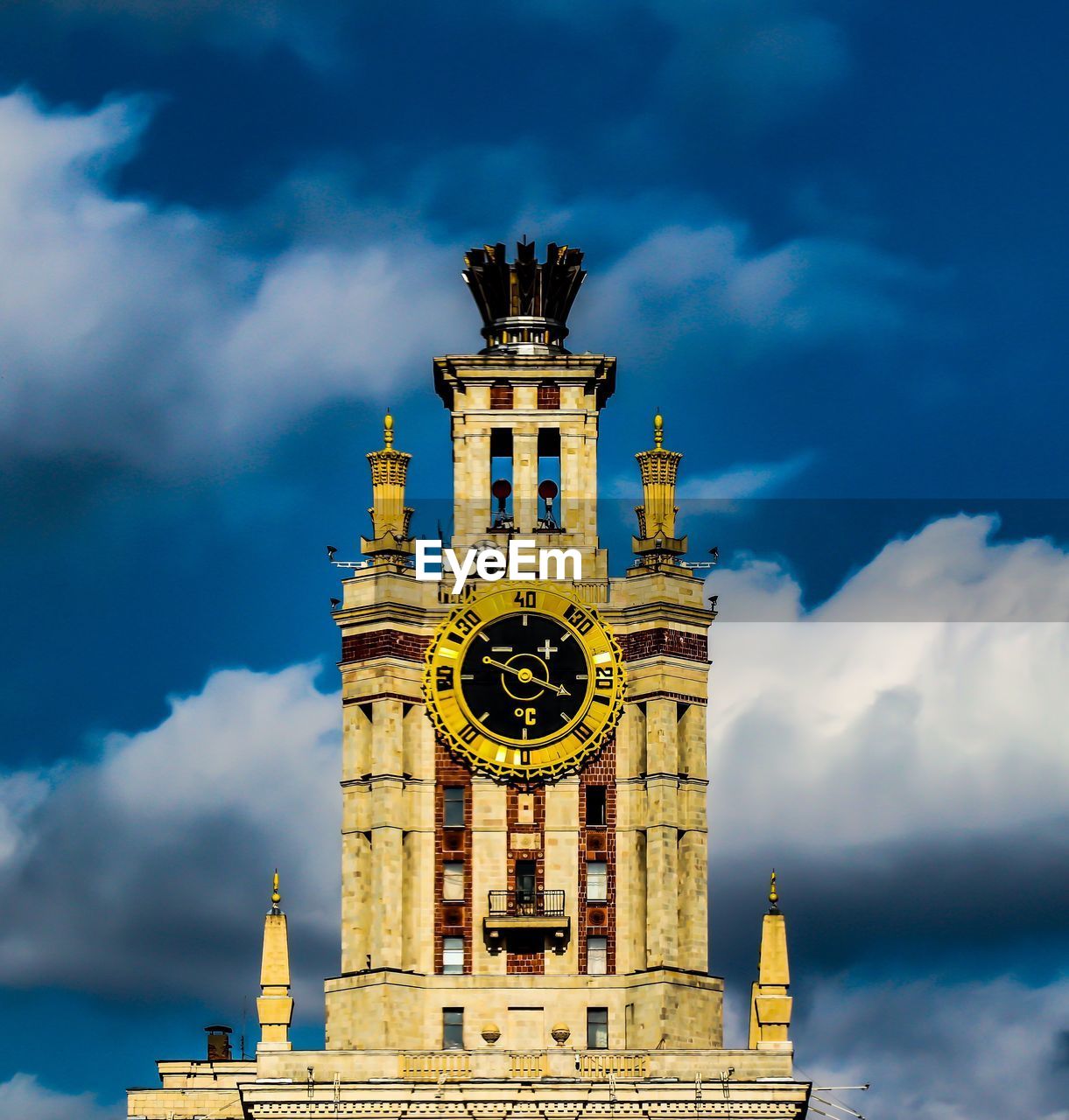 LOW ANGLE VIEW OF CLOCK TOWER AGAINST BUILDING