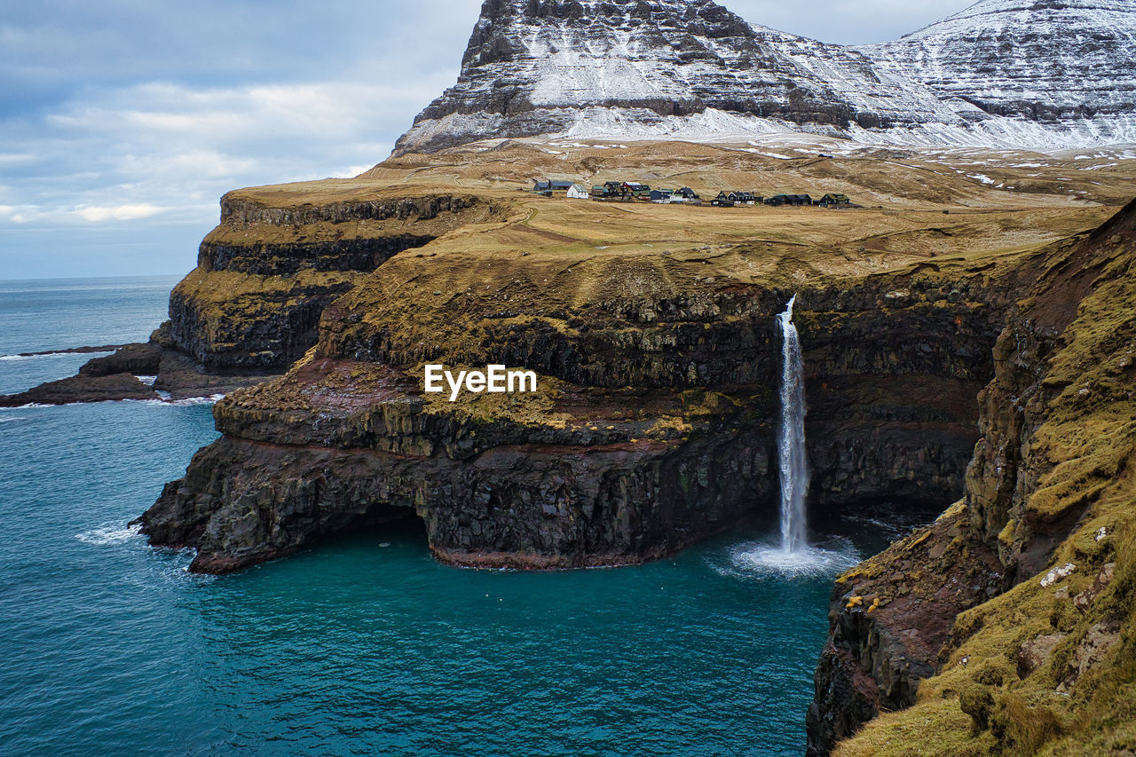 Scenic view of sea waterfall against sky