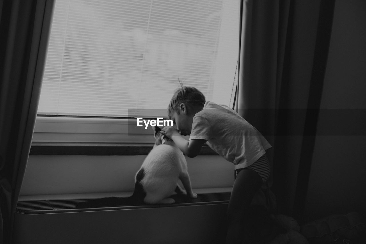 Man sitting by window at home