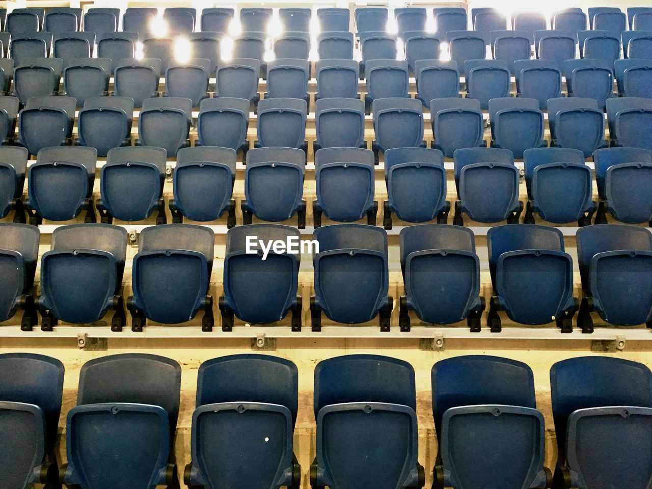 Empty blue chairs in stadium