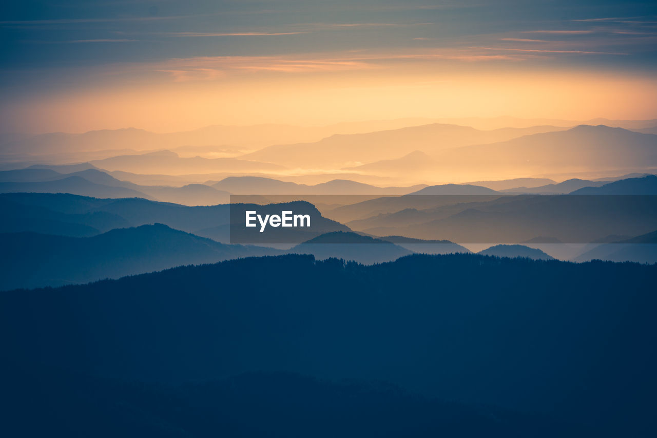 Scenic view of silhouette mountains against sky during sunset