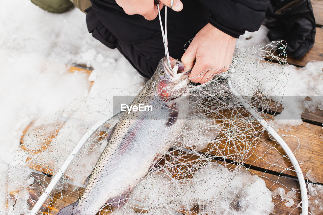 HIGH ANGLE VIEW OF PERSON WORKING ON SNOW