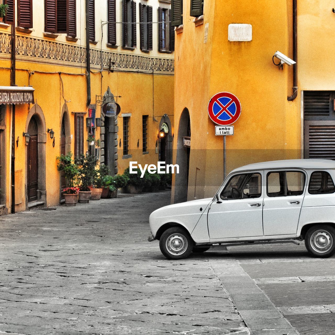 Car parked on street against buildings