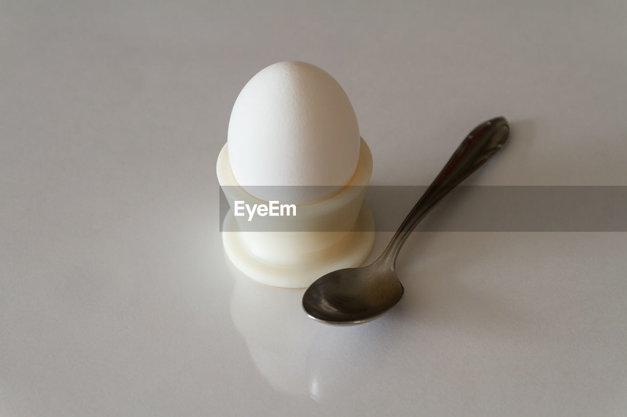 Close-up of eggcup over white table