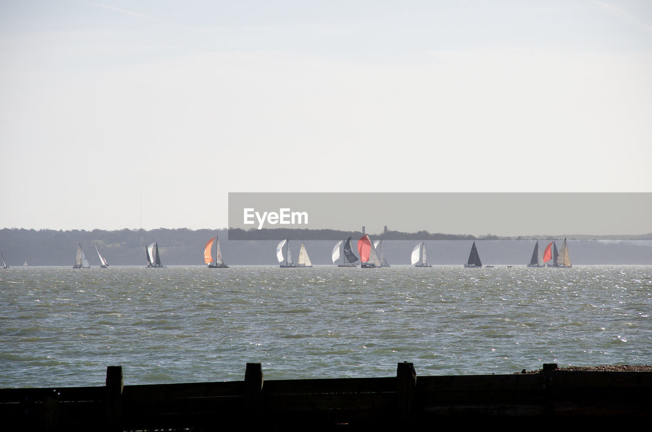 PEOPLE AT SEA AGAINST CLEAR SKY