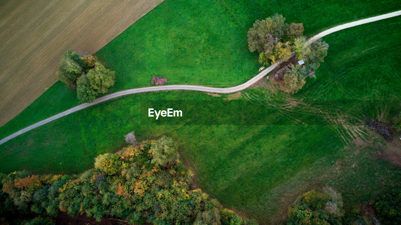 aerial photography, plant, green, aerial view, high angle view, environment, landscape, nature, no people, land, scenics - nature, beauty in nature, growth, tree, day, transportation, tranquility, outdoors, rural scene, road, tranquil scene, water, field, non-urban scene