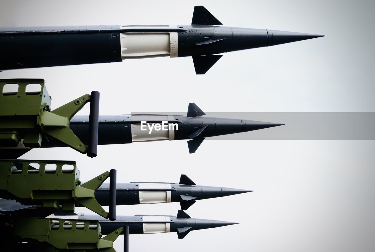 Low angle view of military rockets against sky